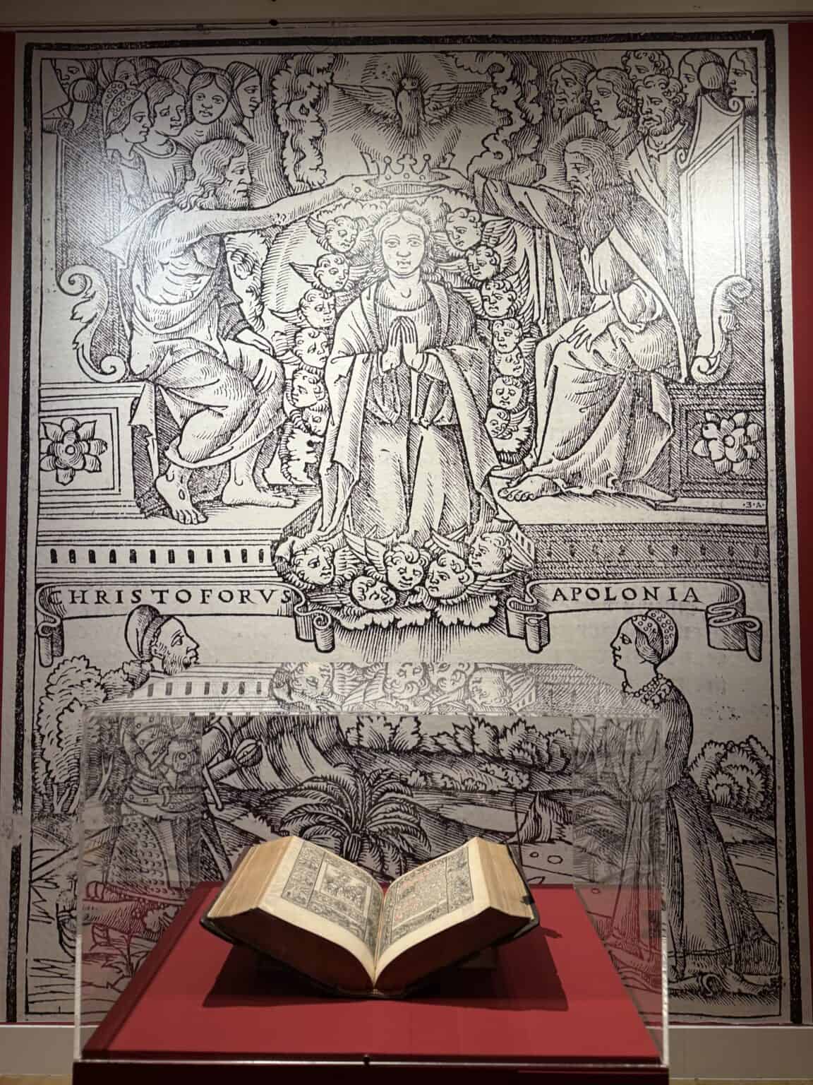 Djelo "Das Deutsch Römisch Brevier" (1518.) iz fonda NSK izloženo pred uvećanom preslikom ilustracije iz Brevijara na kojoj su prikazani Krsto i Apolonija Frankopan / Izvor: nsk.hr